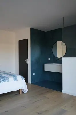 a bedroom with a bed and a mirror on the wall at Les chambres Toussaint in Pianottoli-Caldarello