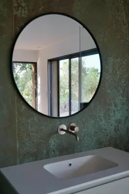 a mirror over a sink in a bathroom with a window at Les chambres Toussaint in Pianottoli-Caldarello