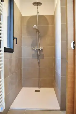 a shower with a shower head in a bathroom at Amandula Bergerie Sotta hyper cozy in Sotta