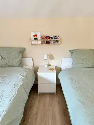 a bedroom with two twin beds and a night stand at CASA ANPÀ Maison Vue Mer in Lecci