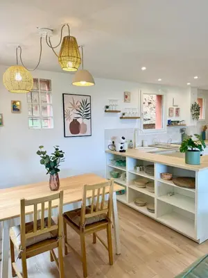 a kitchen with a wooden table and chairs at CASA ANPÀ Maison Vue Mer in Lecci