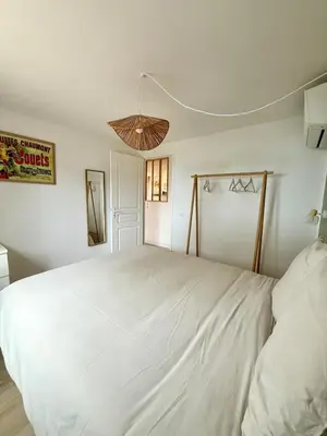 a bedroom with a large white bed in a room at CASA ANPÀ Maison Vue Mer in Lecci