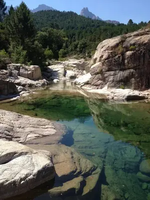 a pool of water in a river with rocks at CASA ANPÀ Maison Vue Mer in Lecci