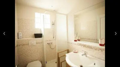 a bathroom with a sink and a toilet and a mirror at Villa ALETTI MJ piscine privée Porto Vecchio in Porto-Vecchio