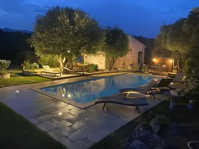 a swimming pool with lounge chairs next to a house at Villa ALETTI MJ piscine privée Porto Vecchio in Porto-Vecchio