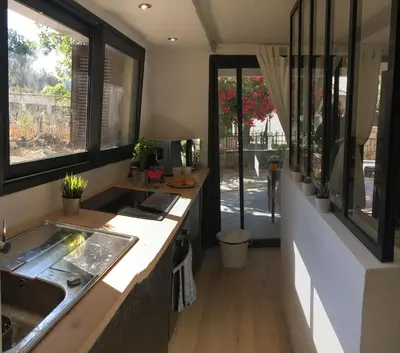 a kitchen with a sink and some windows at Beau Studio au pied de la Cidatelle in Porto-Vecchio