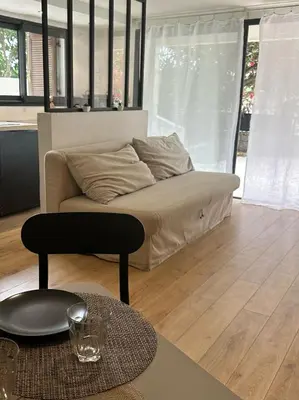 a living room with a couch and a table at Beau Studio au pied de la Cidatelle in Porto-Vecchio
