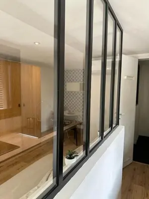 a room with glass windows and a bathroom at Beau Studio au pied de la Cidatelle in Porto-Vecchio