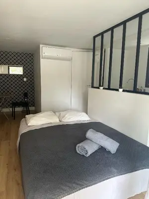 a bedroom with a bed with two towels on it at Beau Studio au pied de la Cidatelle in Porto-Vecchio
