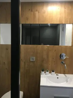 a bathroom with a sink and a mirror at Beau Studio au pied de la Cidatelle in Porto-Vecchio
