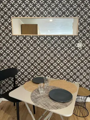 a table with plates and glasses on top of it at Beau Studio au pied de la Cidatelle in Porto-Vecchio