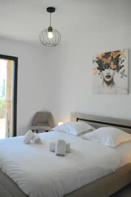 a bedroom with a bed with two towels on it at Alivu bergerie Sotta hyper cosy in Sotta