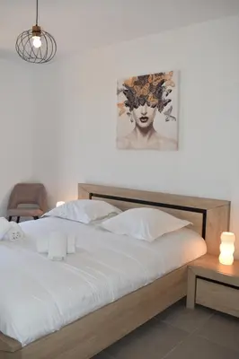 a bedroom with a bed with a painting on the wall at Alivu bergerie Sotta hyper cosy in Sotta