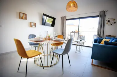 a dining room and living room with a table and chairs at Giulietta - Spacious Terrace - by TGB in Pietrosella
