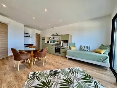 a living room with a couch and a table at Domaine LUMISTELLA 2 in Porticcio