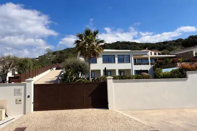 a bed sitting next to a swimming pool at Domaine LUMISTELLA 2 in Porticcio