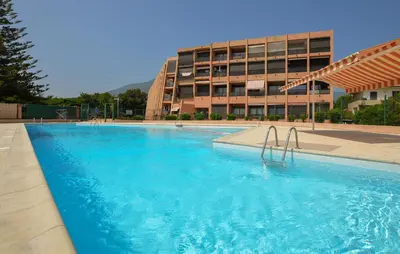 a large swimming pool in front of a building at Studio Piscine Et Plage in Furiani
