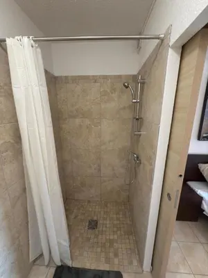 a bathroom with a shower with a shower curtain at Beautiful accommodation, private residence in Linguizzetta
