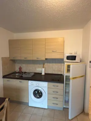 a kitchen with a washing machine and a microwave at Beautiful accommodation, private residence in Linguizzetta