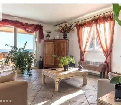a living room with a couch and a table at Villa tasche-vecchio in Porto-Vecchio