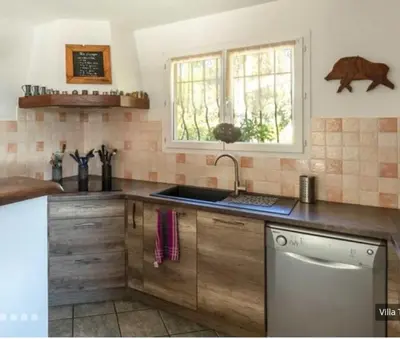 a kitchen with a sink and a window at Villa tasche-vecchio in Porto-Vecchio