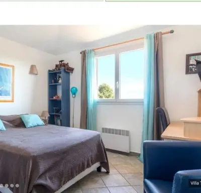 a bedroom with a bed and a window at Villa tasche-vecchio in Porto-Vecchio