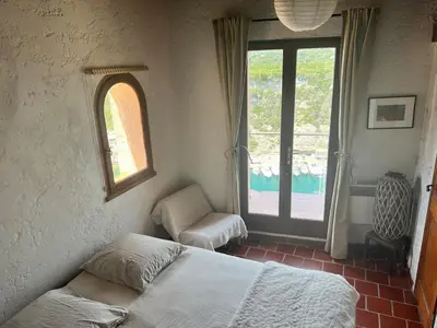 a bedroom with a bed and a window at Tana Torricella in Bonifacio