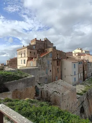 a group of buildings on top of a city at Tana Torricella in Bonifacio