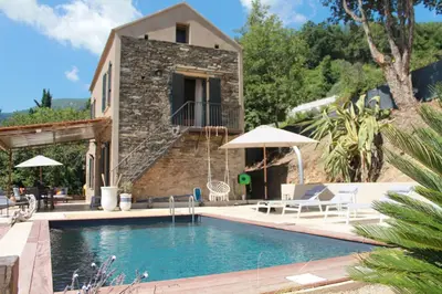 a villa with a swimming pool and a house at La Casuccia in Venzolasca