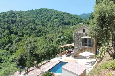 a villa with a swimming pool in the mountains at La Casuccia in Venzolasca