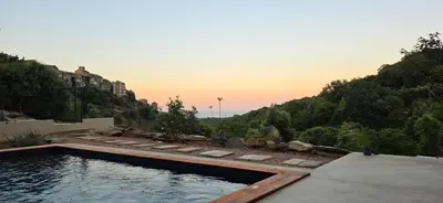a swimming pool with a view of a mountain at La Casuccia in Venzolasca