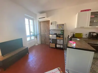 a kitchen with a table and a counter top at Superbe Appartement au coeur d ajaccio in Ajaccio