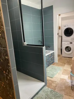 a bathroom with a shower with a washer and dryer at Superbe Appartement au coeur d ajaccio in Ajaccio