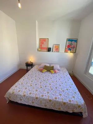 a bedroom with a bed with a comforter and pillows at Superbe Appartement au coeur d ajaccio in Ajaccio