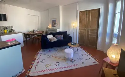 a living room with a blue couch and a rug at Superbe Appartement au coeur d ajaccio in Ajaccio