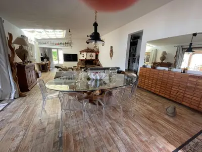 a dining room with a glass table and chairs at Villa les pieds dans l'eau in Bonifacio