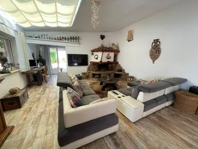 a living room with two couches and a fireplace at Villa les pieds dans l'eau in Bonifacio