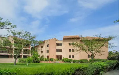 a large building with trees in front of it at Gorgeous Apartment In Moriani Plage in Moriani Plage