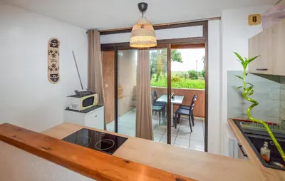 a kitchen with a view of a dining room at Gorgeous Apartment In Moriani Plage in Moriani Plage