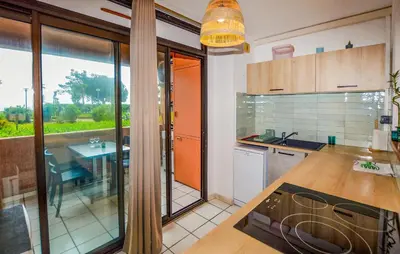 a kitchen with a counter and a table in it at Gorgeous Apartment In Moriani Plage in Moriani Plage