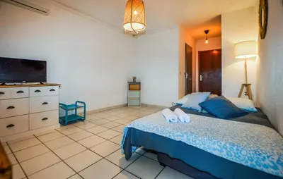 a bedroom with a bed and a dresser and a television at Gorgeous Apartment In Moriani Plage in Moriani Plage