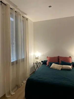 a bedroom with a large bed and a window at U San Petru -Locations de chambres in Bains de Guitera