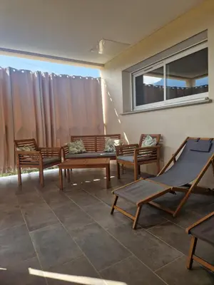a group of chairs and a hammock on a patio at Agapanthe location in San-Nicolao