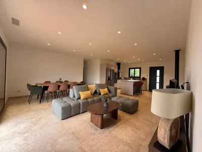 a living room with a couch and a table at Chez Claudine & Adrien in Figari