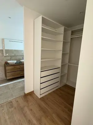a bathroom with a white closet with a sink at Chez Claudine & Adrien in Figari