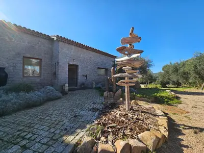 a directional sign in front of a building at Bella Stella in Coggia