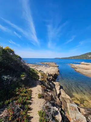 a path along the shore of a body of water at Bella Stella in Coggia