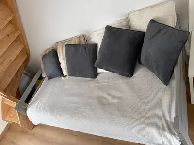 a couch with three black pillows on it at Casa Tassinca in Tasso