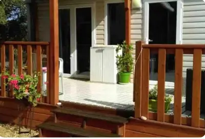 a front porch of a house with potted plants at Chalet cosy in Pianottoli-Caldarello