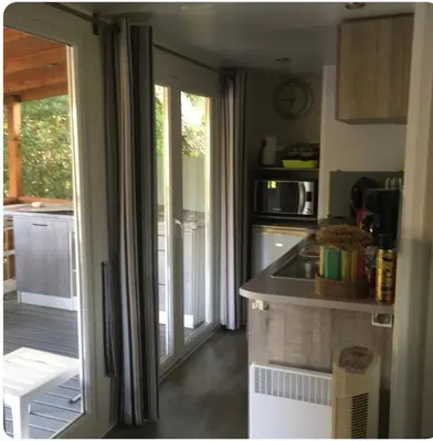 a kitchen with a sink and a counter top at Chalet cosy in Pianottoli-Caldarello